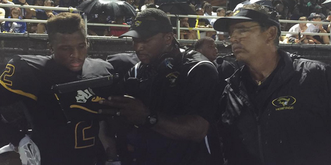 Plantation American Heritage coaching up a play from the sidelines, during the Patriots 23-22 loss to DeMatha Catholic, Photo by Brandon Odoi.