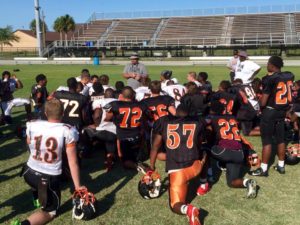 Coach Wilkinson talking to his team during spring football practices (Photo Credit: Cocoa Tigers Football)