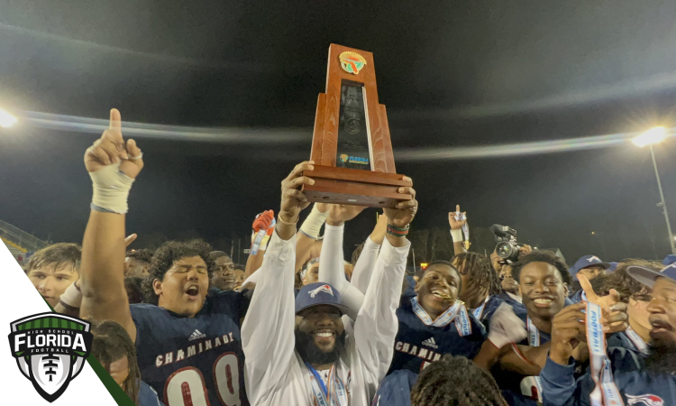 Chaminade-Madonna HC Dameon Jones holds up the Class 1M State Championship trophy after the Lions defeated Clearwater Central Catholic 48-14 on Thu., Dec. 8, 2022 at Gene Cox Stadium in Tallahassee, Fla. [Joshua Wilson/FloridaHSFootball.com]