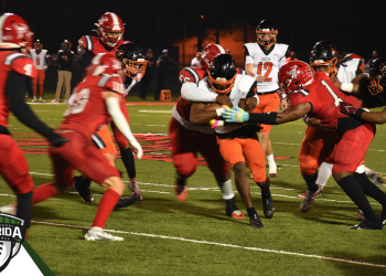 Cocoa's Cedrick Hawkins carries the ball with a swarm of Bradford tacklers coming at him during the Class 2S State Semifinal on Fri. Dec. 2, 2022 at David Hurse Stadium in Starke, Fla. [Joshua Wilson/FloridaHSFootball.com]