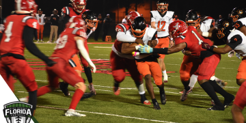 Cocoa's Cedrick Hawkins carries the ball with a swarm of Bradford tacklers coming at him during the Class 2S State Semifinal on Fri. Dec. 2, 2022 at David Hurse Stadium in Starke, Fla. [Joshua Wilson/FloridaHSFootball.com]