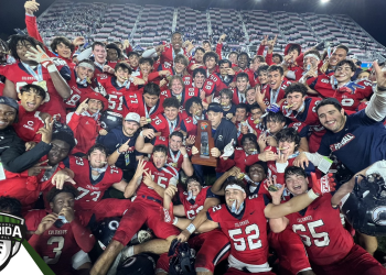 The Columbus Explorers hold poses with the Class 4M State Championship trophy after defeating Apopka 16-13 in overtime on Saturday, December 17, 2022 at DRV PNK Stadium in Fort Lauderdale, Fla. [Joshua Wilson/FloridaHSFootball.com]