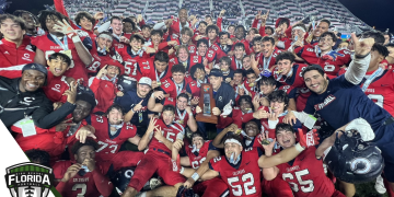 The Columbus Explorers hold poses with the Class 4M State Championship trophy after defeating Apopka 16-13 in overtime on Saturday, December 17, 2022 at DRV PNK Stadium in Fort Lauderdale, Fla. [Joshua Wilson/FloridaHSFootball.com]