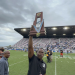 Lake Wales head coach Tavaris Johnson holds up the state championship trophy, the first to be won by the Highlanders' football program on Friday, December 16, 2022 at DRV PNK Stadium in Fort Lauderdale, Fla. [Joshua Wilson/FloridaHSFootball.com}