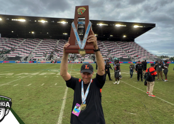 Bill Castle holds up the 2022 Class 4S State Championship after Lakeland defeated Venice 21-14 on Saturday, December 17, 2022 at DRV PNK Stadium in Fort Lauderdale, Fla. Castle announced his retirement on Tuesday, January 3, 2023 after 52 years total at Lakeland including the last 47 as head coach.