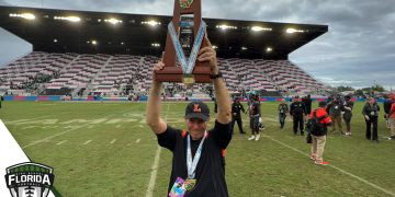Bill Castle holds up the 2022 Class 4S State Championship after Lakeland defeated Venice 21-14 on Saturday, December 17, 2022 at DRV PNK Stadium in Fort Lauderdale, Fla. Castle announced his retirement on Tuesday, January 3, 2023 after 52 years total at Lakeland including the last 47 as head coach.