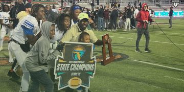 Travis Roland poses with the Class 3S State Championship trophy after the Buccaneers defeated St. Augustine 21-19 on Thu. Dec. 7, 2023 at Ken Riley Field at Bragg Memorial Stadium in Tallahassee, Fla. [Joshua Wilson/FloridaHSFootball.com]