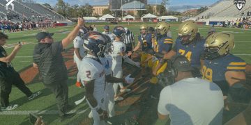 Homestead and St. Thomas Aquinas (Fort Lauderdale) team captains meet at midfield prior to the Class 3M State Championship game on Sat, Dec. 9, 2023 at Ken Riley Field at Bragg Memorial Stadium in Tallahassee, Fla. [Joshua Wilson/FloridaHSFootball.com]
