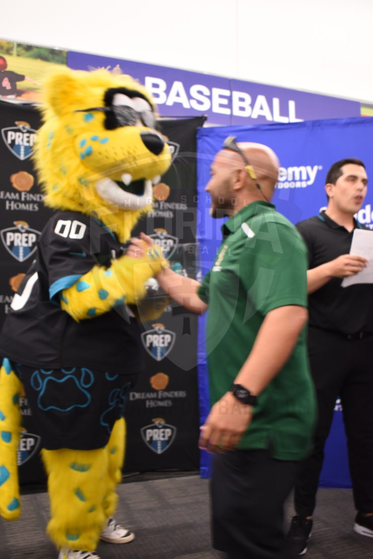 Ed White (Jacksonville) Flag Football Head Coach Bachir Saoud shakes Jaxson De Ville's hand after being announced as the Jaguars PREP 2024 Coach of the Year at the 2024 Jaguars All-PREP Flag Football recognition event held at Academy Sports + Outdoors on Southside Blvd. on Wed. May 8, 2024, in Jacksonville, Fla. [Joshua Wilson/FloridaHSFootball.com]