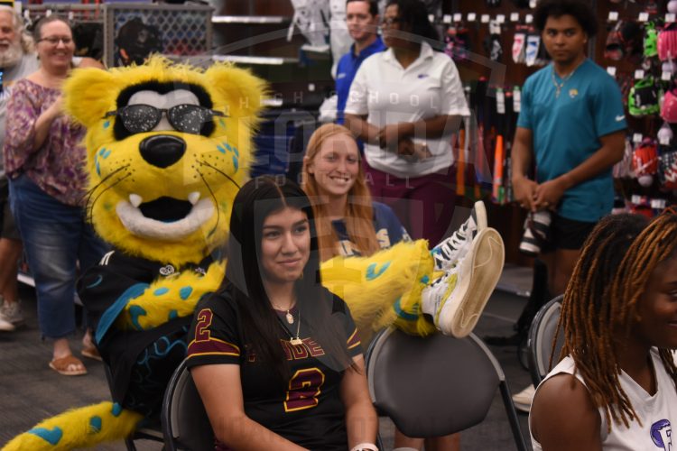 Jaxson De Ville takes a seat next to Sandalwood Flag Football QB Ashley Purdy at the 2024 Jaguars All-PREP Flag Football recognition event held at Academy Sports + Outdoors on Southside Blvd. on Wed. May 8, 2024, in Jacksonville, Fla. [Joshua Wilson/FloridaHSFootball.com]