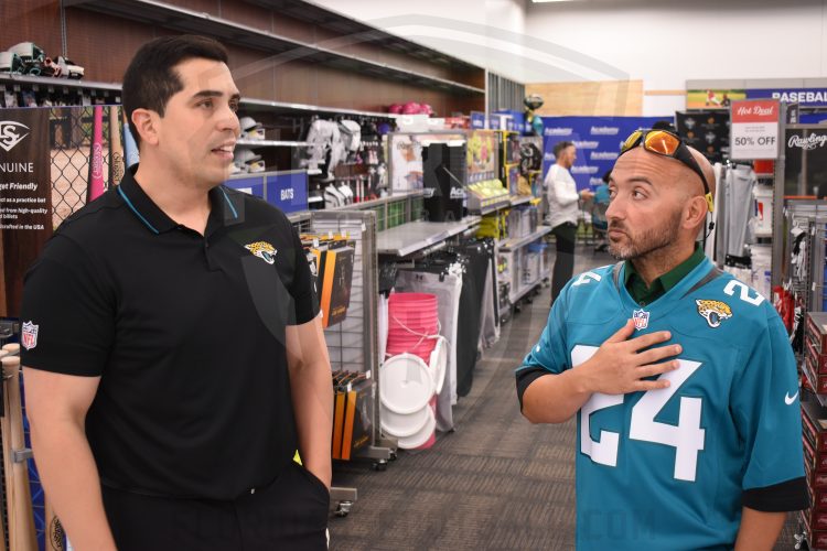 Adriel Rocha, Jacksonville Jaguars VP of Community Impact and Football Development talks with 2024 Coach of the Year, Bachir Saoud of Ed White (Jacksonville) during the 2024 Jaguars All-PREP Flag Football recognition event held at Academy Sports + Outdoors on Southside Blvd. on Wed. May 8, 2024, in Jacksonville, Fla. [Joshua Wilson/FloridaHSFootball.com]