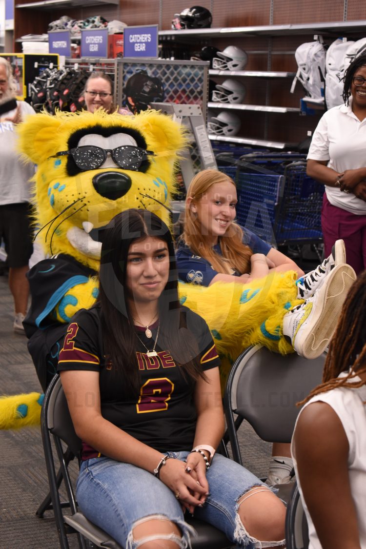 Jaxson De Ville takes a seat next to Sandalwood Flag Football QB Ashley Purdy at the 2024 Jaguars All-PREP Flag Football recognition event held at Academy Sports + Outdoors on Southside Blvd. on Wed. May 8, 2024, in Jacksonville, Fla. [Joshua Wilson/FloridaHSFootball.com]