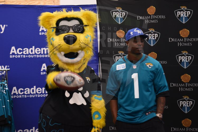 Jacksonville Jaguars RB Travis Etienne Jr. hangs with Jaxson De Ville at the 2024 Jaguars All-PREP Flag Football recognition event held at Academy Sports + Outdoors on Southside Blvd. on Wed. May 8, 2024, in Jacksonville, Fla. [Joshua Wilson/FloridaHSFootball.com]