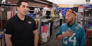 Adriel Rocha, Jacksonville Jaguars VP of Community Impact and Football Development talks with 2024 Coach of the Year, Bachir Saoud of Ed White (Jacksonville) during the 2024 Jaguars All-PREP Flag Football recognition event held at Academy Sports + Outdoors on Southside Blvd. on Wed. May 8, 2024, in Jacksonville, Fla. [Joshua Wilson/FloridaHSFootball.com]