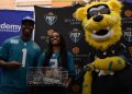 London Jenkins, Fleming Island poses with Travis Etienne Jr and Jaxson De Ville of the Jacksonville Jaguars after receiving the 2024 Player of the Year Award at the 2024 Jaguars All-PREP Flag Football recognition event held at Academy Sports + Outdoors on Southside Blvd. on Wed. May 8, 2024, in Jacksonville, Fla. [Joshua Wilson/FloridaHSFootball.com]