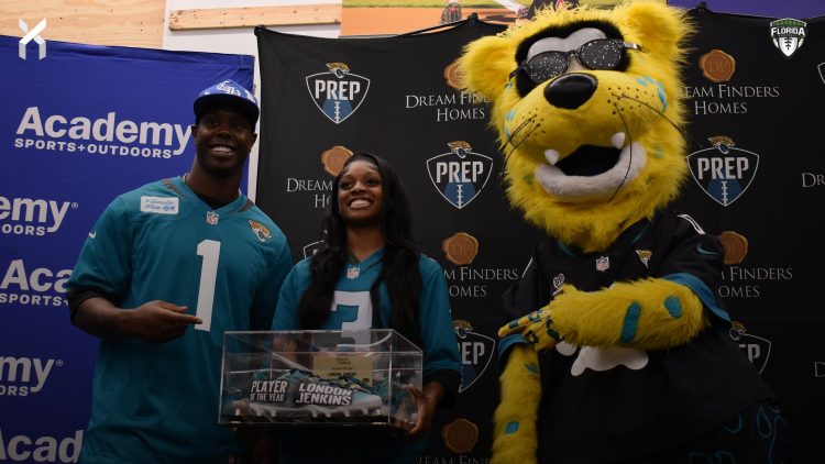 London Jenkins, Fleming Island poses with Travis Etienne Jr and Jaxson De Ville of the Jacksonville Jaguars after receiving the 2024 Player of the Year Award at the 2024 Jaguars All-PREP Flag Football recognition event held at Academy Sports + Outdoors on Southside Blvd. on Wed. May 8, 2024, in Jacksonville, Fla. [Joshua Wilson/FloridaHSFootball.com]