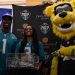 London Jenkins, Fleming Island poses with Travis Etienne Jr and Jaxson De Ville of the Jacksonville Jaguars after receiving the 2024 Player of the Year Award at the 2024 Jaguars All-PREP Flag Football recognition event held at Academy Sports + Outdoors on Southside Blvd. on Wed. May 8, 2024, in Jacksonville, Fla. [Joshua Wilson/FloridaHSFootball.com]