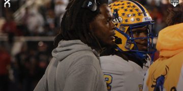 Miami Northwestern Head Coach Teddy Bridgewater and QB Leon Strawder huddle up the rest of the Bulls offense during a time out during the recent 2024 FHSAA Class 3A State Championship. Strawder was among three athletes that stood out in the 2024 FHSAA Class 3A State Championship Game on Sat. Dec. 14, 2024, at South Dade Kia Field at Pitbull Stadium in Miami [Joshua Wilson/FloridaHSFootball.com]