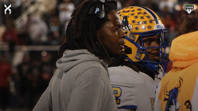 Miami Northwestern Head Coach Teddy Bridgewater and QB Leon Strawder huddle up the rest of the Bulls offense during a time out during the recent 2024 FHSAA Class 3A State Championship. Strawder was among three athletes that stood out in the 2024 FHSAA Class 3A State Championship Game on Sat. Dec. 14, 2024, at South Dade Kia Field at Pitbull Stadium in Miami [Joshua Wilson/FloridaHSFootball.com]