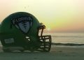 The Florida High School Football Helmet on display on the beach as the sun rises. [Joshua Wilson/FloridaHSFootball.com]