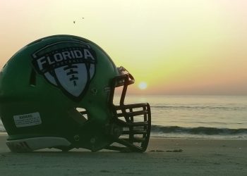 The Florida High School Football Helmet on display on the beach as the sun rises. [Joshua Wilson/FloridaHSFootball.com]