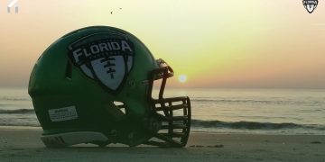 The Florida High School Football Helmet on display on the beach as the sun rises. [Joshua Wilson/FloridaHSFootball.com]