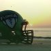 The Florida High School Football Helmet on display on the beach as the sun rises. [Joshua Wilson/FloridaHSFootball.com]
